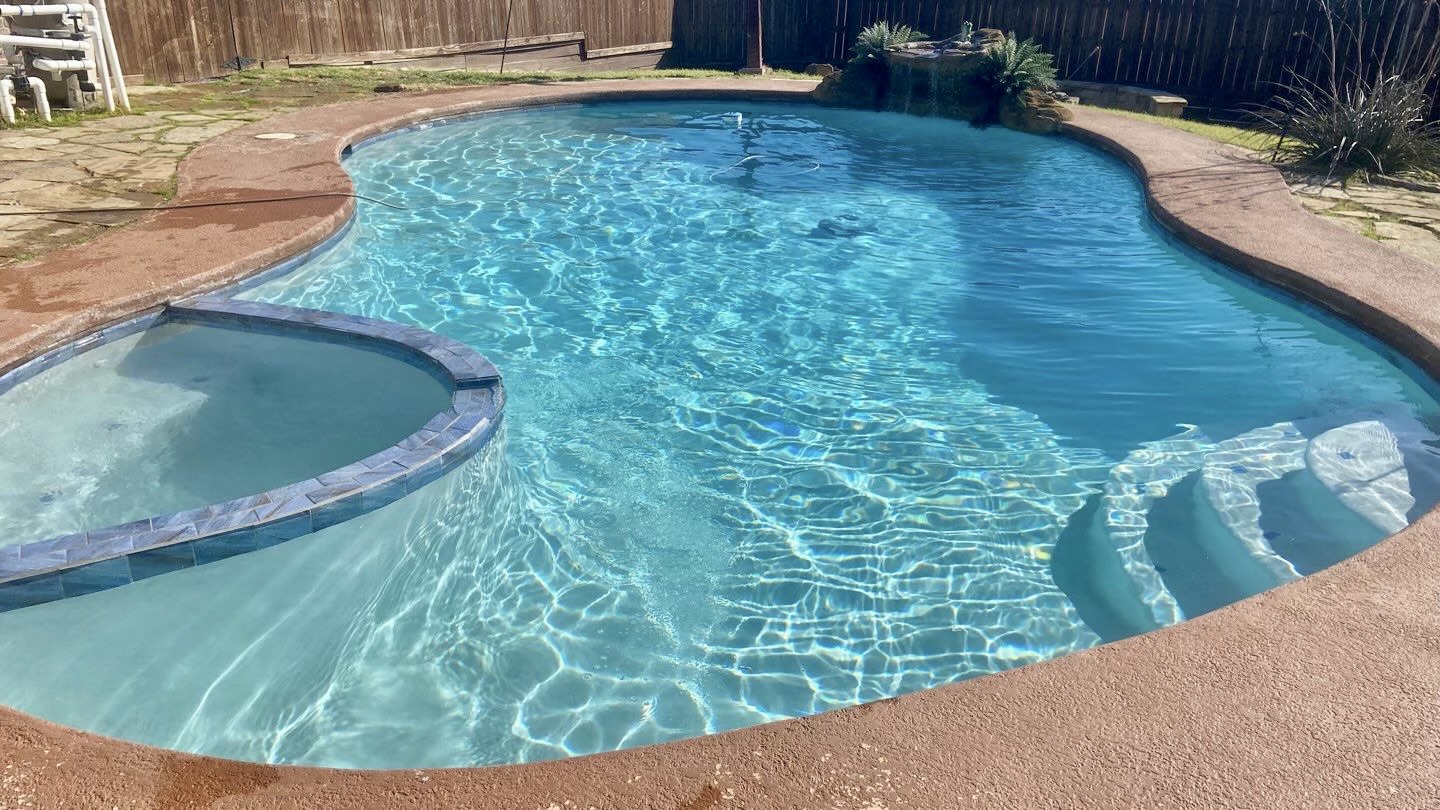 Beautiful maintained freeform pool with crystal clear water and natural stone features